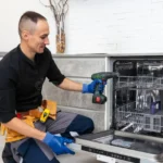 Melbourne Dishwasher Repairs technician explaining dishwasher maintenance tips to a customer.